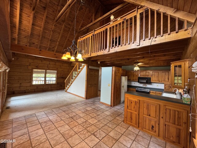 2452 Skyview Way, Dandridge, TN 37725 - kitchen featuring black microwave, high vaulted ceiling, dark countertops, open floor plan, and white fridge with ice dispenser