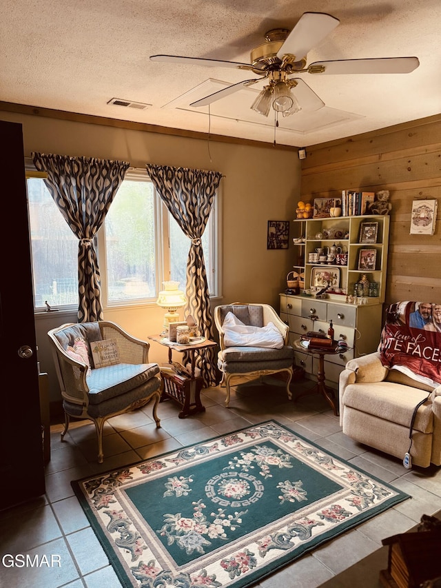 2452 Skyview Way, Dandridge, TN 37725 - sitting room with tile patterned flooring, a ceiling fan, a textured ceiling, and wooden walls