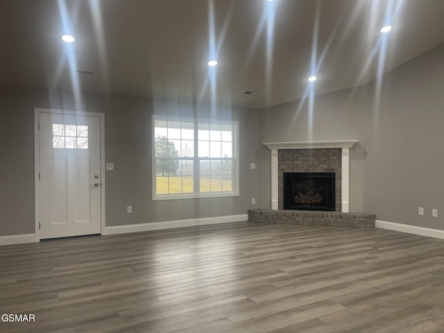 unfurnished living room with a fireplace and hardwood / wood-style floors