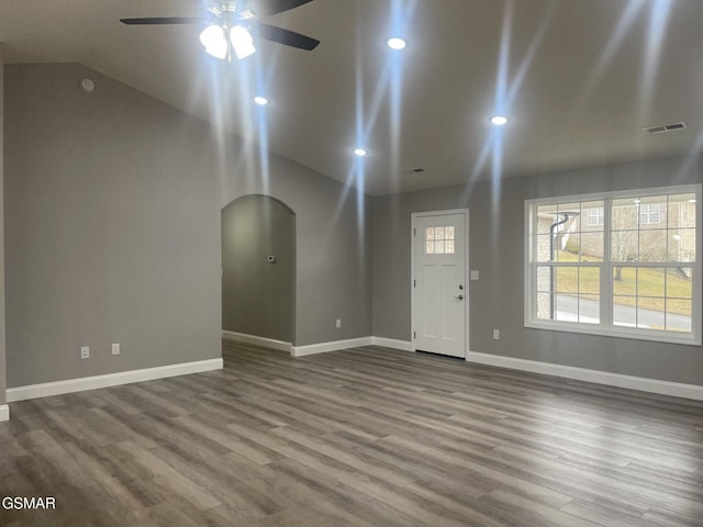 foyer entrance with ceiling fan, lofted ceiling, and wood-type flooring