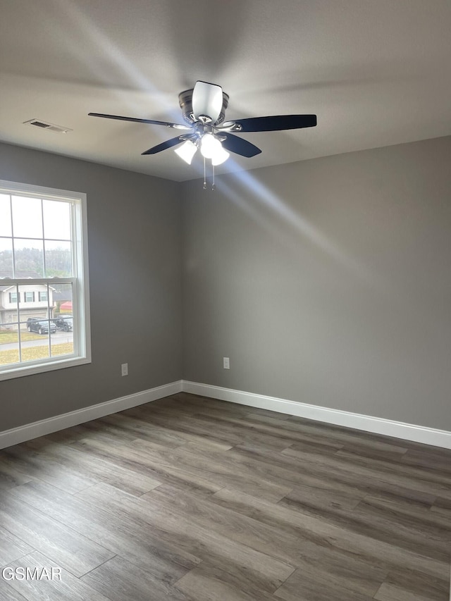 spare room featuring wood-type flooring and ceiling fan