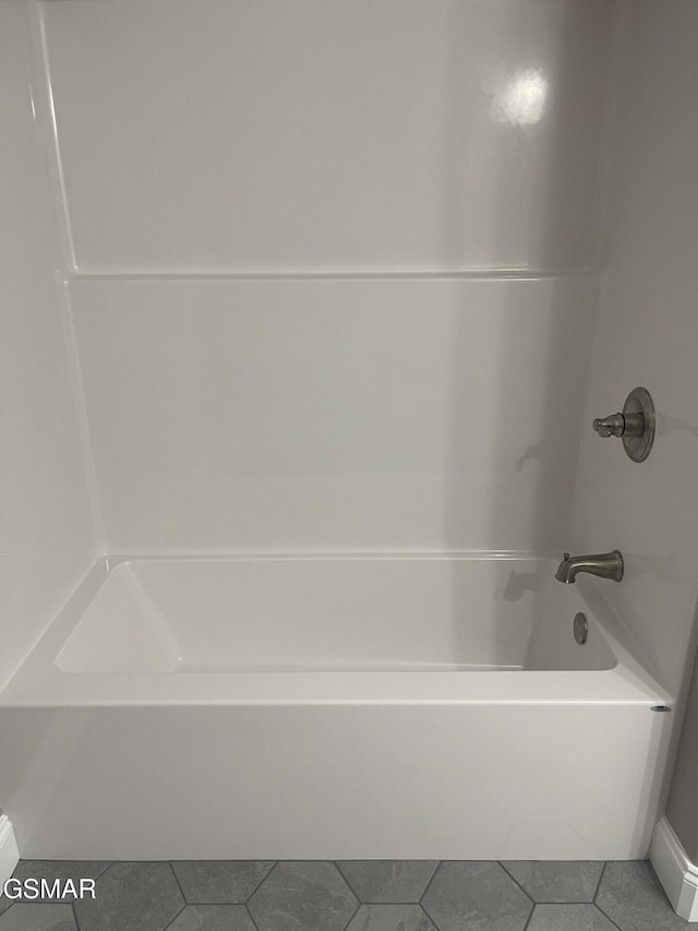 bathroom featuring  shower combination and tile patterned flooring