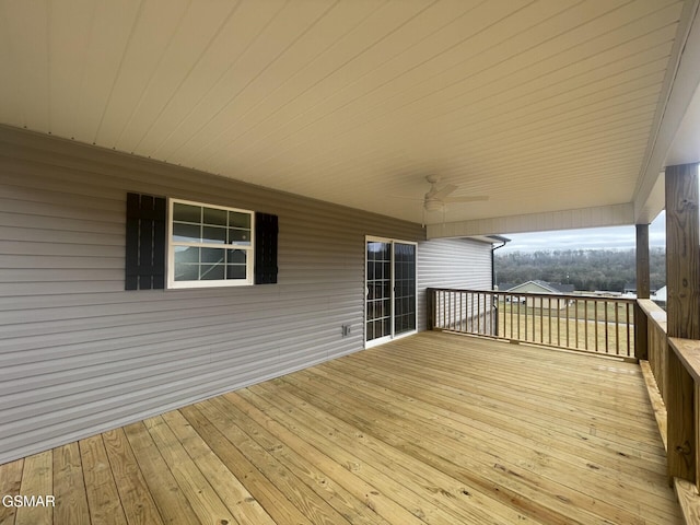 wooden deck featuring ceiling fan