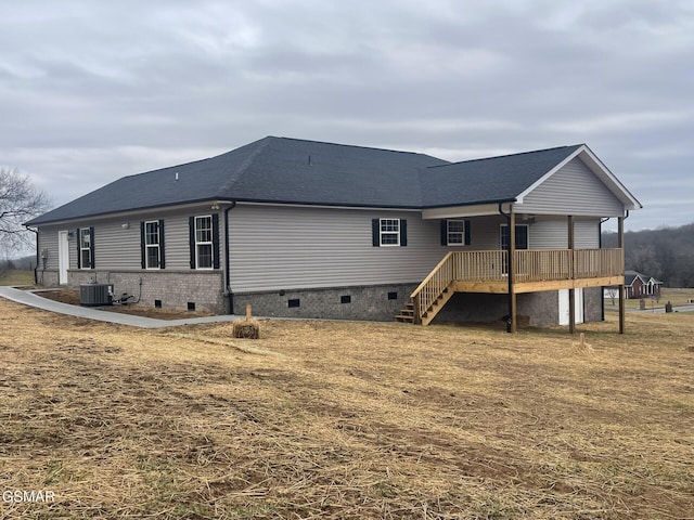 rear view of house with a yard, central AC, and a deck