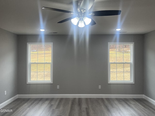 unfurnished room with hardwood / wood-style floors and ceiling fan