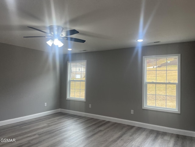 unfurnished room with hardwood / wood-style flooring and ceiling fan