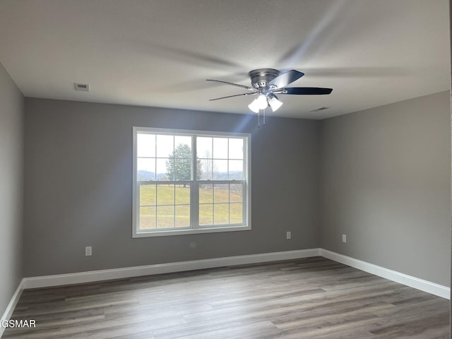 spare room featuring ceiling fan and light wood-type flooring