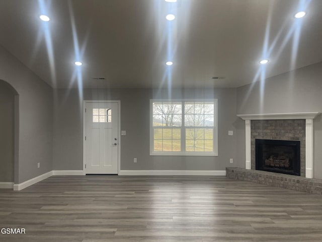 unfurnished living room featuring hardwood / wood-style floors and a fireplace