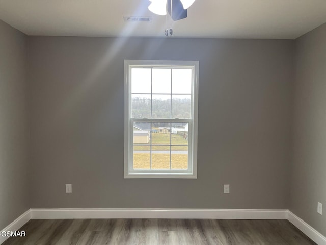 empty room with hardwood / wood-style floors and ceiling fan