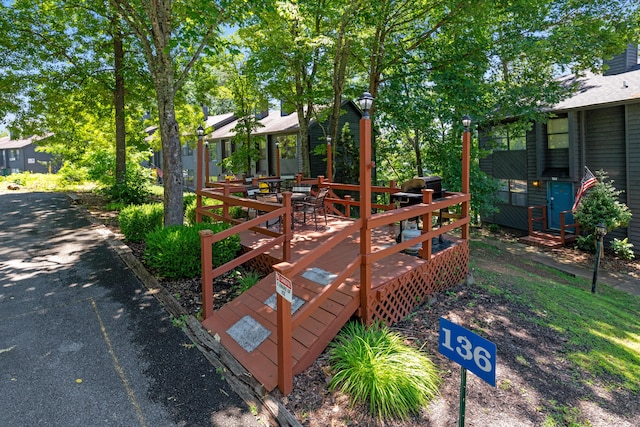 view of playground with a wooden deck