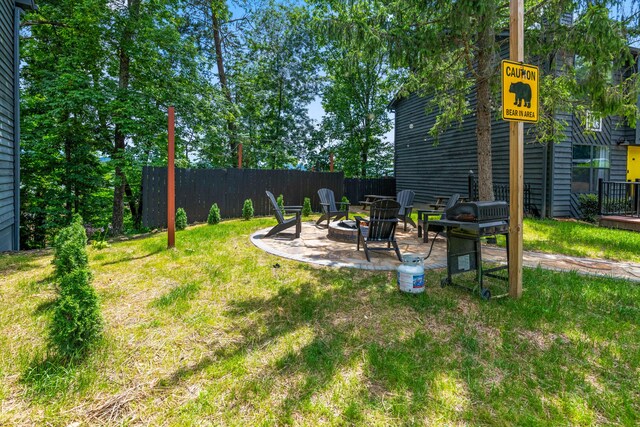 view of yard with an outdoor fire pit and a patio area