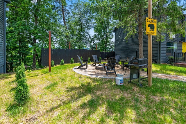 view of yard featuring a patio area and an outdoor fire pit