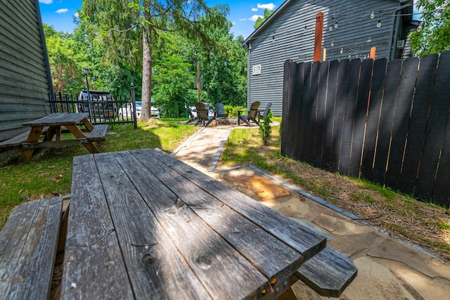 deck with a fire pit and a yard