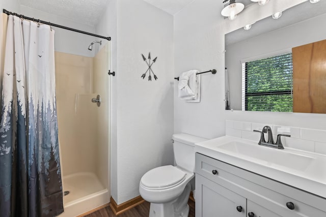 bathroom featuring a textured ceiling, wood-type flooring, vanity, toilet, and a shower with shower curtain