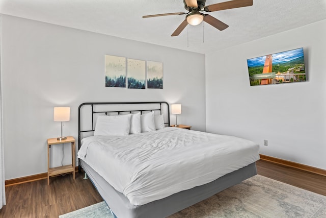 bedroom featuring ceiling fan and dark wood-type flooring