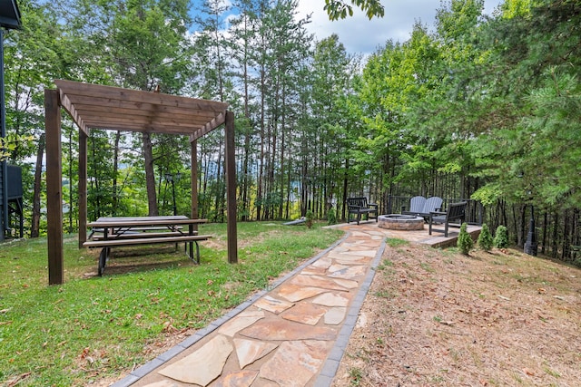 view of home's community featuring an outdoor fire pit, a lawn, and a pergola