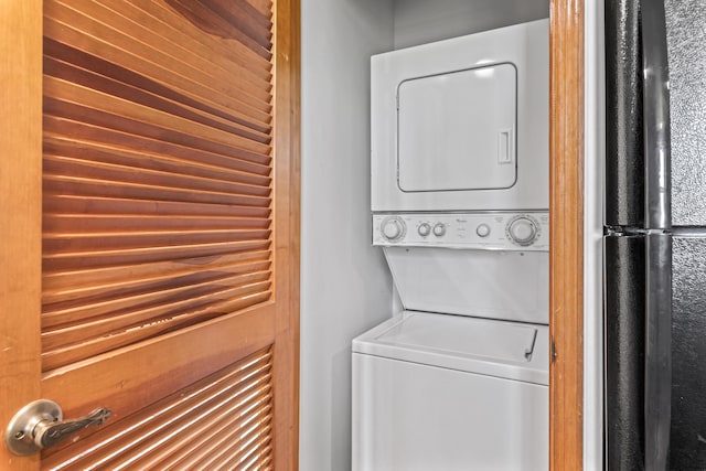 clothes washing area featuring stacked washer / drying machine