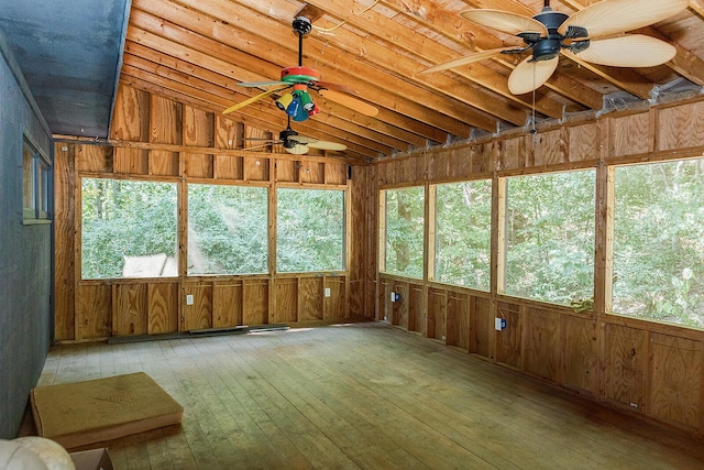 unfurnished sunroom featuring lofted ceiling and a ceiling fan