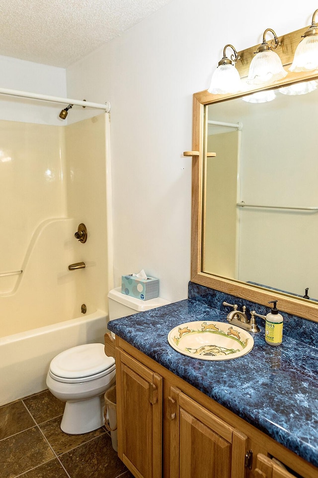 full bath with a textured ceiling, toilet, washtub / shower combination, and vanity