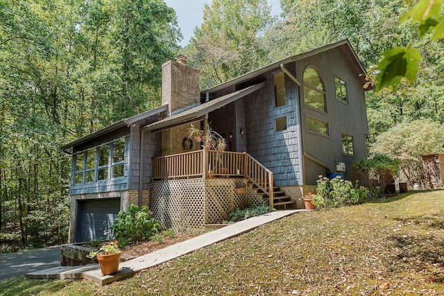 exterior space featuring an attached garage and a chimney