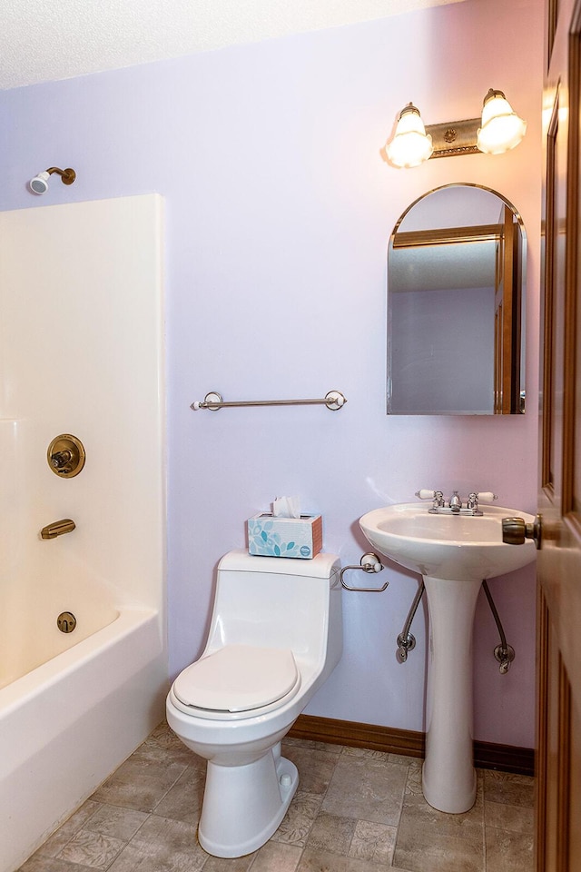 full bathroom featuring a tub, a shower, baseboards, and toilet