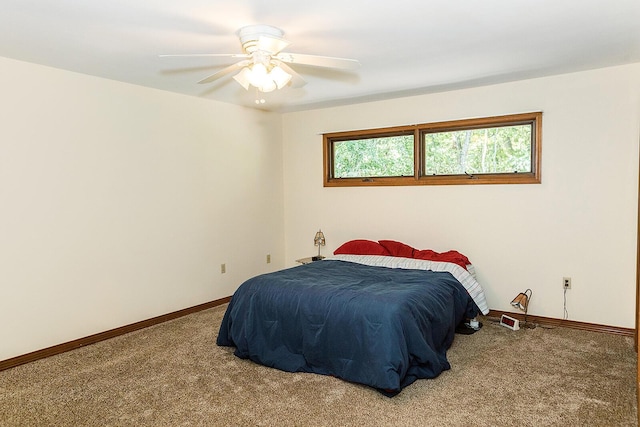 carpeted bedroom with a ceiling fan and baseboards