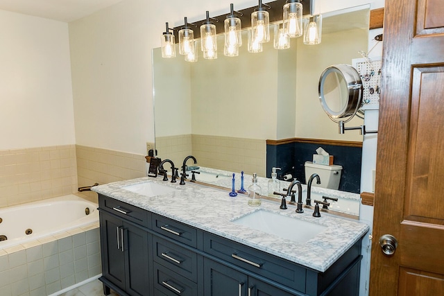 full bathroom featuring a whirlpool tub, double vanity, and a sink