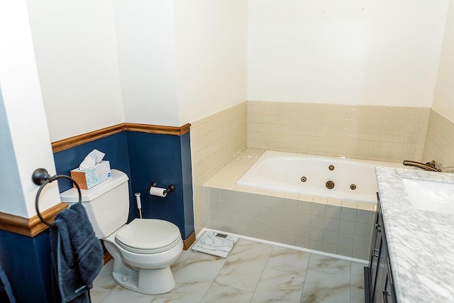 bathroom featuring toilet, marble finish floor, a tub with jets, and vanity