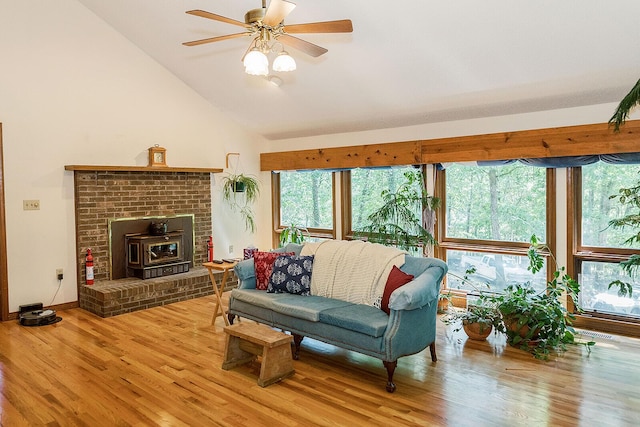 living area with high vaulted ceiling, ceiling fan, baseboards, and wood finished floors