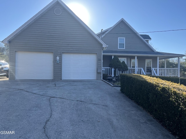 view of front of house with a porch and a garage