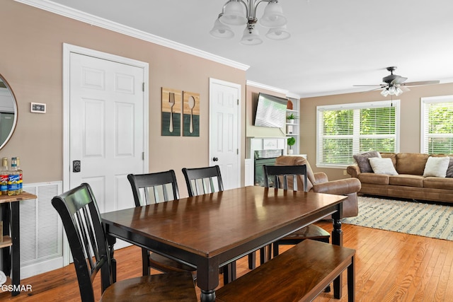 134 Roaring Fork Rd, Gatlinburg, TN 37738 - dining space featuring light wood finished floors, a chandelier, ornamental molding, and a ceiling fan