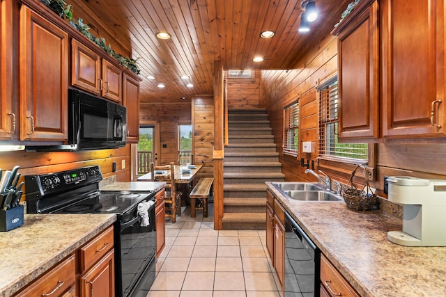 kitchen with wooden walls, sink, black appliances, light tile patterned floors, and wooden ceiling