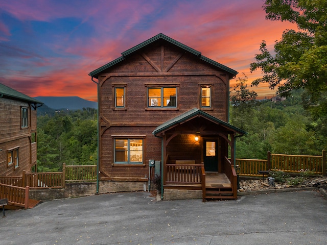 view of front facade featuring a mountain view and covered porch