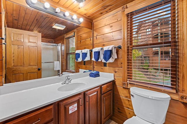 bathroom with vanity, wooden ceiling, toilet, a shower with shower door, and wood walls