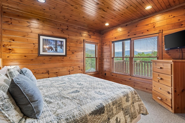 carpeted bedroom featuring wooden ceiling and wooden walls