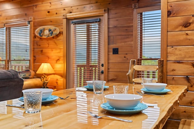 dining space featuring log walls