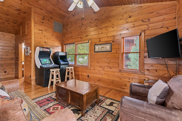 living room featuring light hardwood / wood-style floors, lofted ceiling, wooden walls, and wooden ceiling