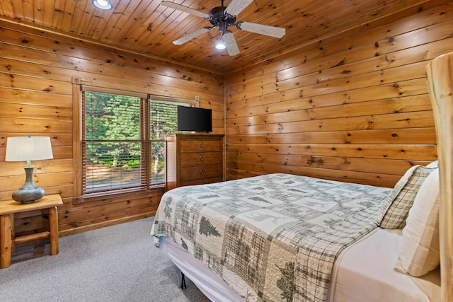 bedroom with carpet flooring, ceiling fan, wooden ceiling, and wooden walls