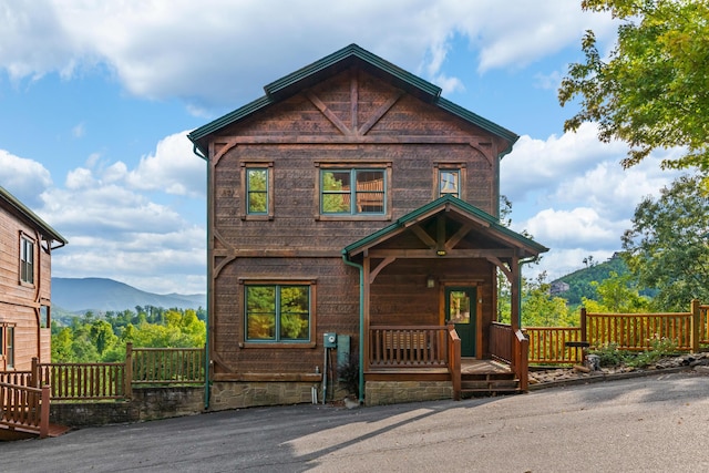 view of front facade featuring a mountain view and a porch