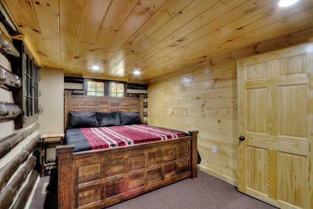 bedroom featuring dark colored carpet, wooden walls, and wood ceiling