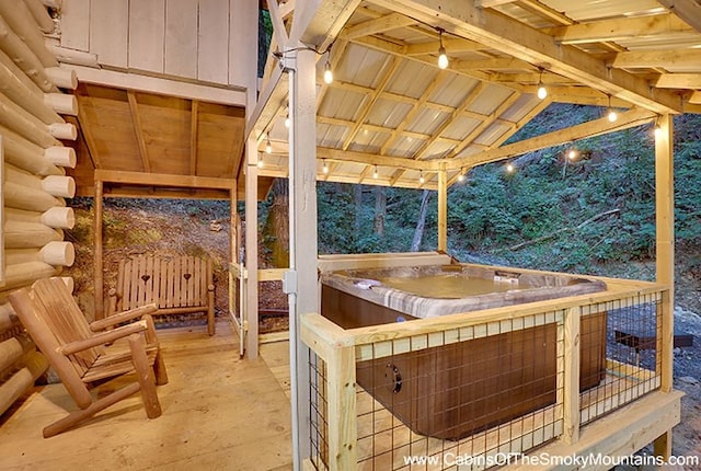 wooden terrace with a hot tub