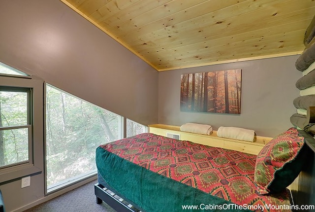 bedroom with carpet, wooden ceiling, and vaulted ceiling