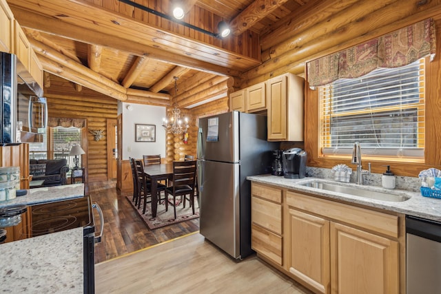 kitchen with hanging light fixtures, appliances with stainless steel finishes, sink, and light brown cabinets