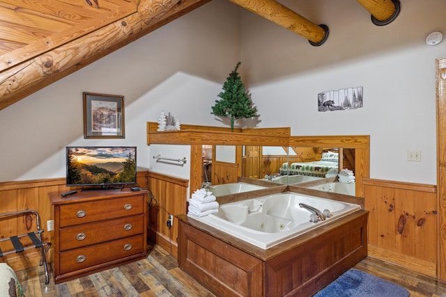 bathroom with lofted ceiling, wood-type flooring, wooden walls, and a bath