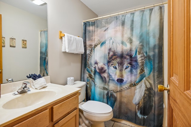 bathroom with vanity, curtained shower, and toilet