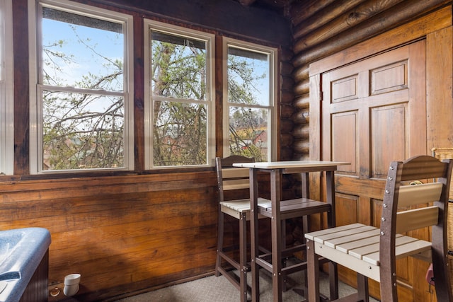 dining space with rustic walls