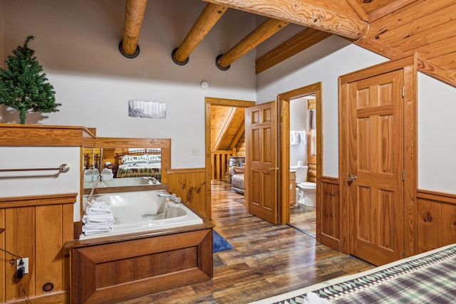 bedroom featuring dark hardwood / wood-style flooring, wooden walls, and beamed ceiling