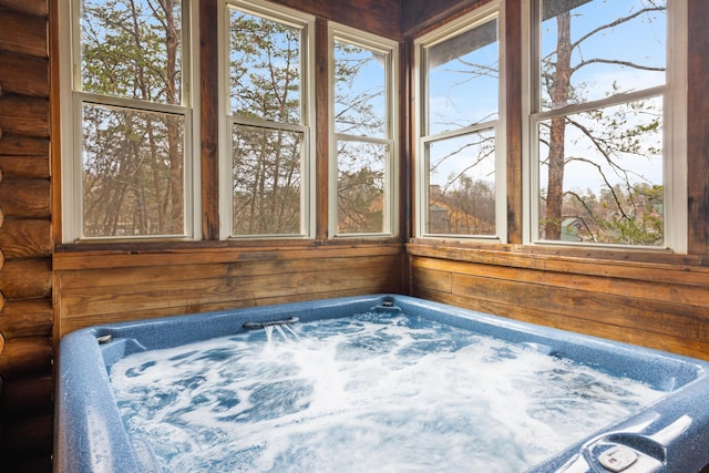 unfurnished sunroom featuring a jacuzzi