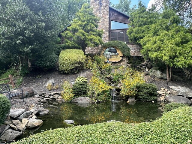 view of yard featuring a small pond