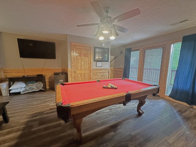 rec room featuring wood walls, billiards, hardwood / wood-style flooring, ceiling fan, and a textured ceiling